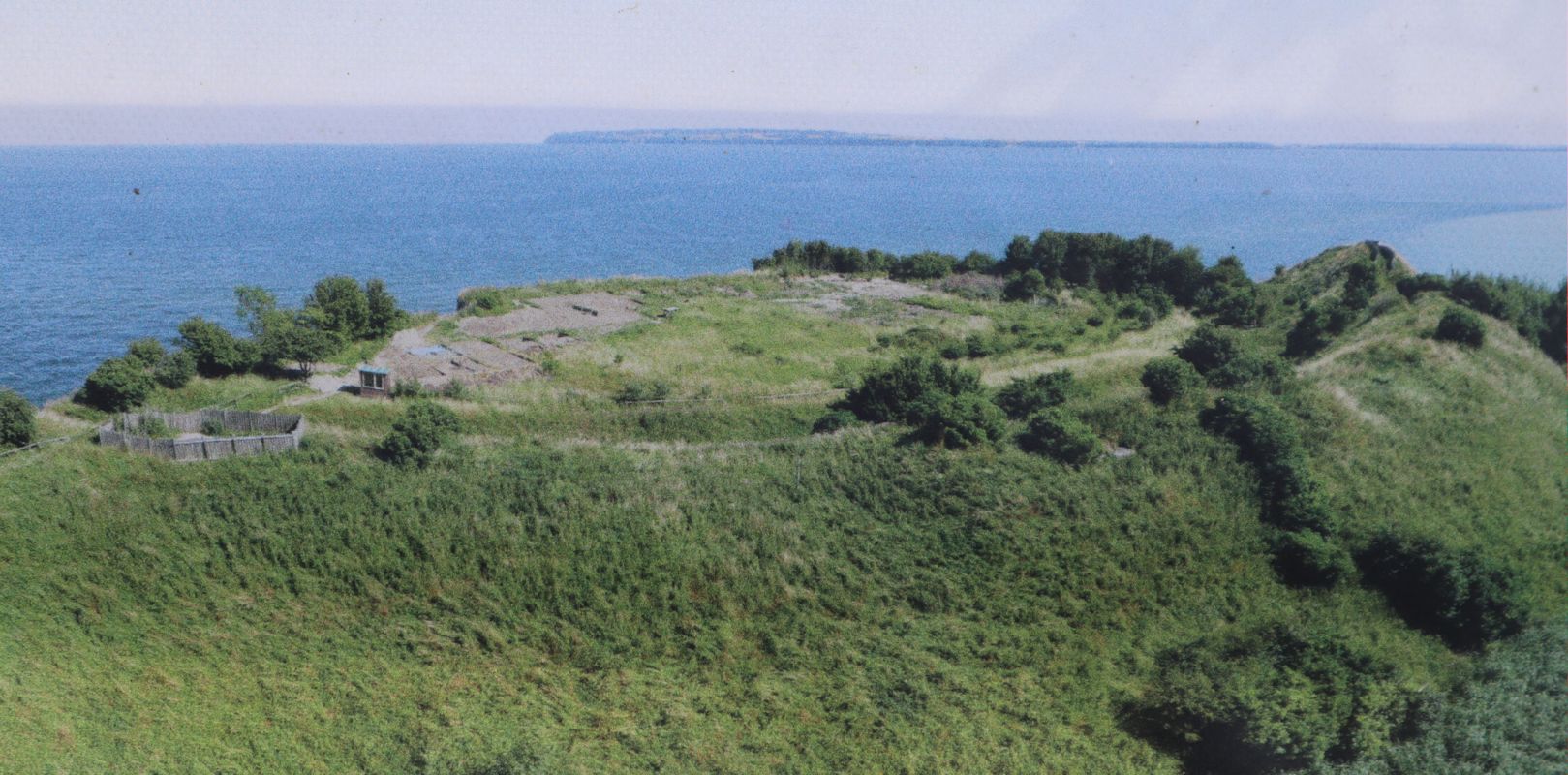 Luftbild der Reste der Jaromarsburg am Kap Arkona, auf einer Infotafel vor der heute wegen Erosion durch das Meer unzugänglichen Burg