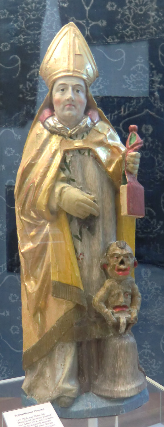 Statue: Theodor mit Glocke und Teufel, um 1500, im Museum des Klosters Disentis