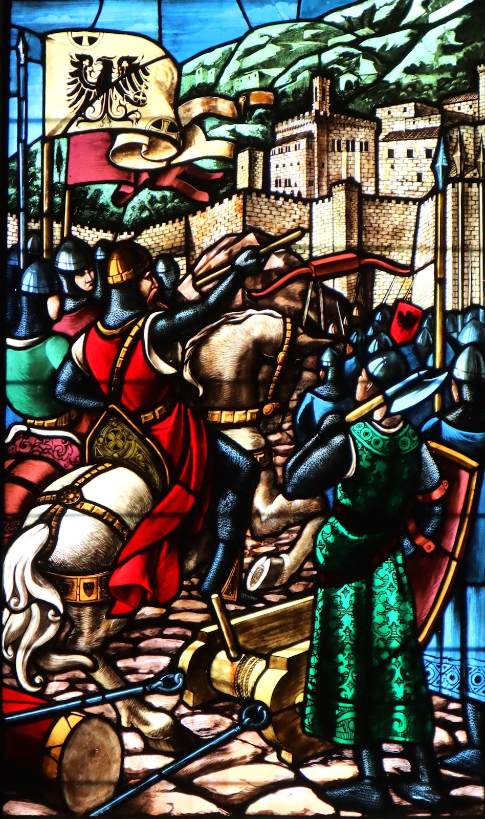 Franciscus Mossmeyer: Kaiser Friedrich I. „Barbarossa” vor Gubbio, das Ubalds Einschreiten dann von der Einnahme bewahrt, Glasfenster, 1922, in der Basilika Sant'Ubald in Gubbio